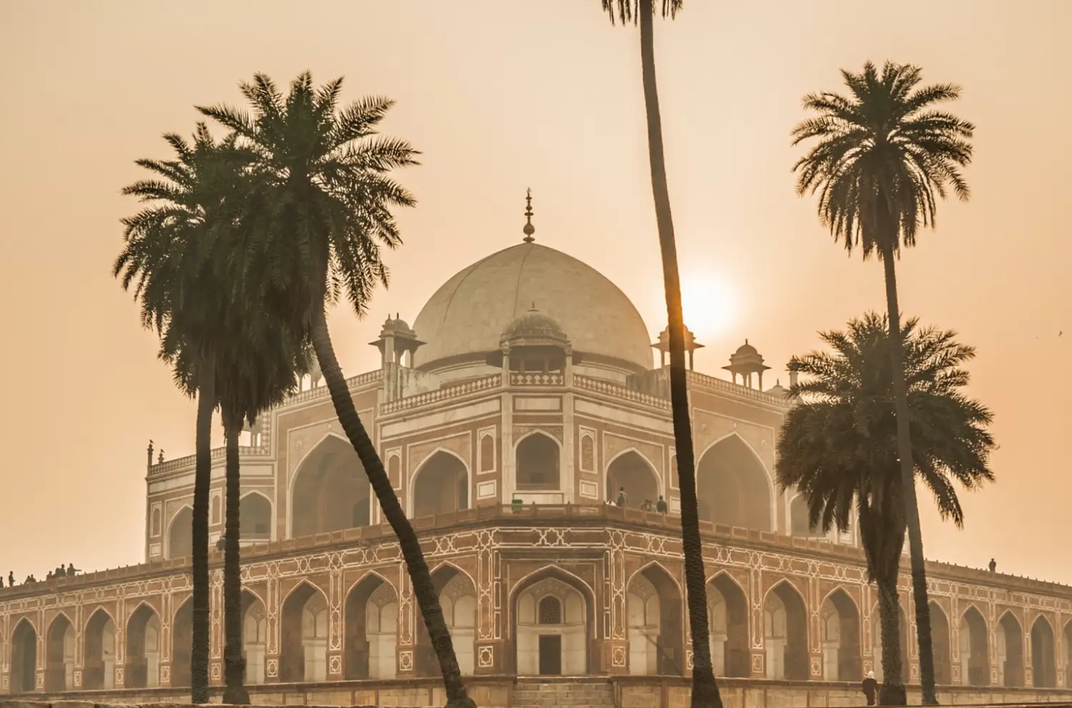 Humayun's Tomb captured at sunrise, with Travel With Vasco's India Group Tour clients exploring the historic site.