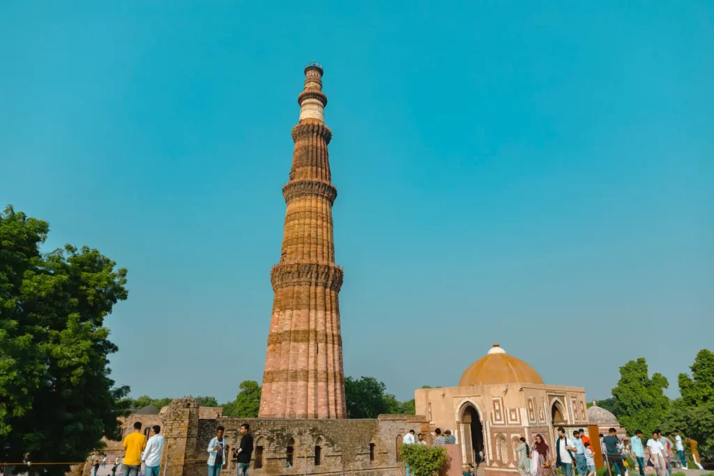 India Tour Packages 10 Guests from Travel With Vasco’s India Group Tour exploring the historic Qutub Minar in Delhi, India.