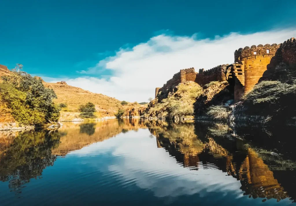 India Tour Packages 1 A serene view of a historic fort by a tranquil lake in Jodhpur, captured during Travel With Vasco's India Group Tour for their clients.