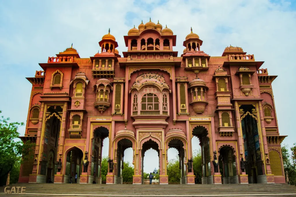 India Tour Packages 7 Patrika Gate in Jaipur, Rajasthan, during an India Group Tour organized by Travel With Vasco, showcasing a vibrant architectural structure with intricate details and domes.