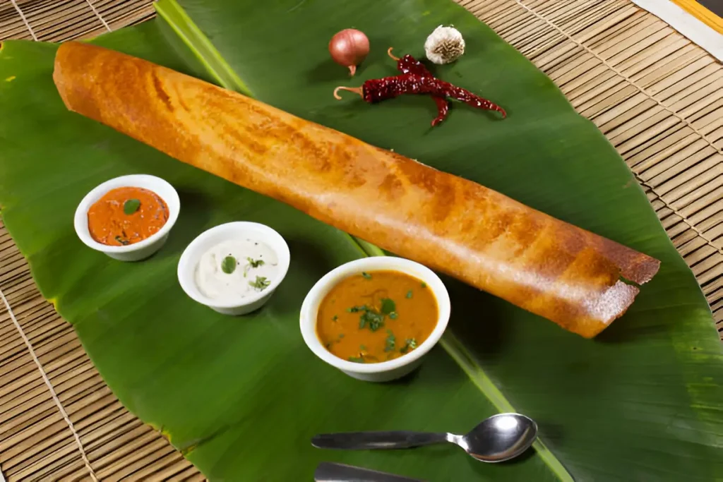 Traditional Indian Food: Must-try dishes when visiting India 4 Masala dosa on banana leaf with both sambar and coconut chutney. South Indian Vegetarian Snack