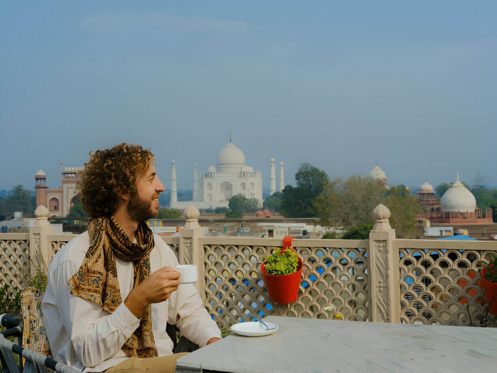 Taj Mahal: Everything You Need To Know 6 man-having-tea-on-roof-top-and-viewing-taj-mahal
