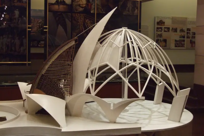 "Architectural model of the Lotus Temple displayed at the Information Centre, showcasing the temple’s petal-like structure and dome design with informational posters in the background."