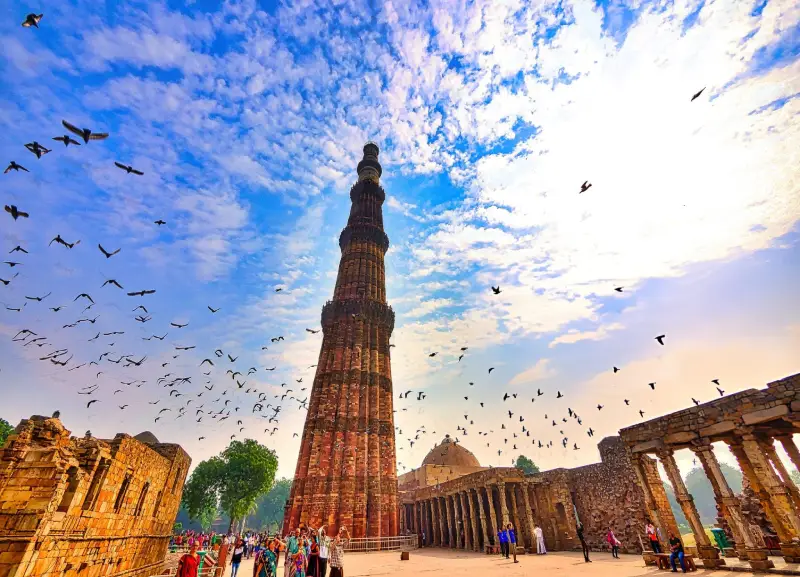 Guests from Travel With Vasco’s India Group Tour exploring the historic Qutub Minar in Delhi, India.