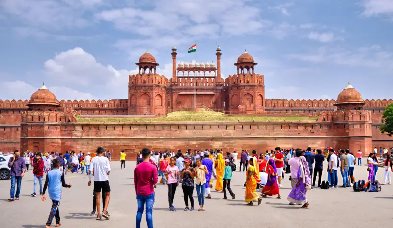The iconic Red Fort in Delhi, a UNESCO World Heritage Site, bustling with visitors. Travel With Vasco's guests explored this historic monument during their India Group Tour as part of the India tour service.