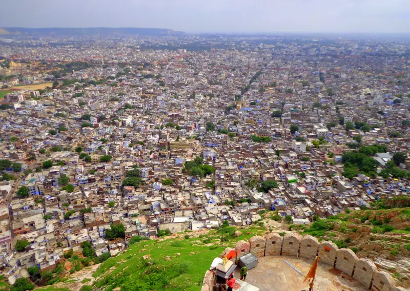 Nahargarh Fort 1 "Panoramic view of Jaipur city from Nahargarh Fort, showing a densely packed urban landscape stretching into the horizon with fort ramparts and green hillside in the foreground."