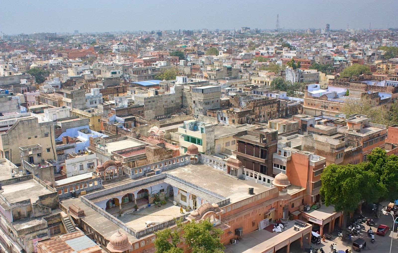 Aerial view of a historic city in India, showcasing intricate architecture and vibrant city life during an India Group Tour organized by Travel with Vasco.