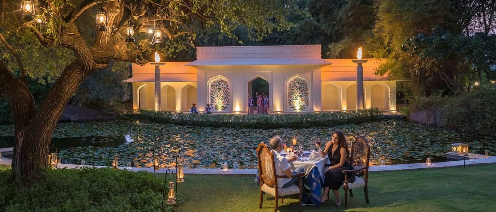 How do I book a Jaipur tour with you? 1 "Guests of Travel With Vasco enjoying a romantic dinner by the lotus pond, as part of their India Group Tour on the Golden Triangle Tour."